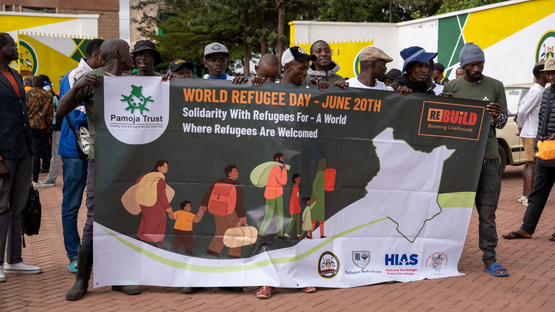 People posing for a photo as they commemorate World Refugee Day in the Dandara Stadium in Nairobi, Kenya