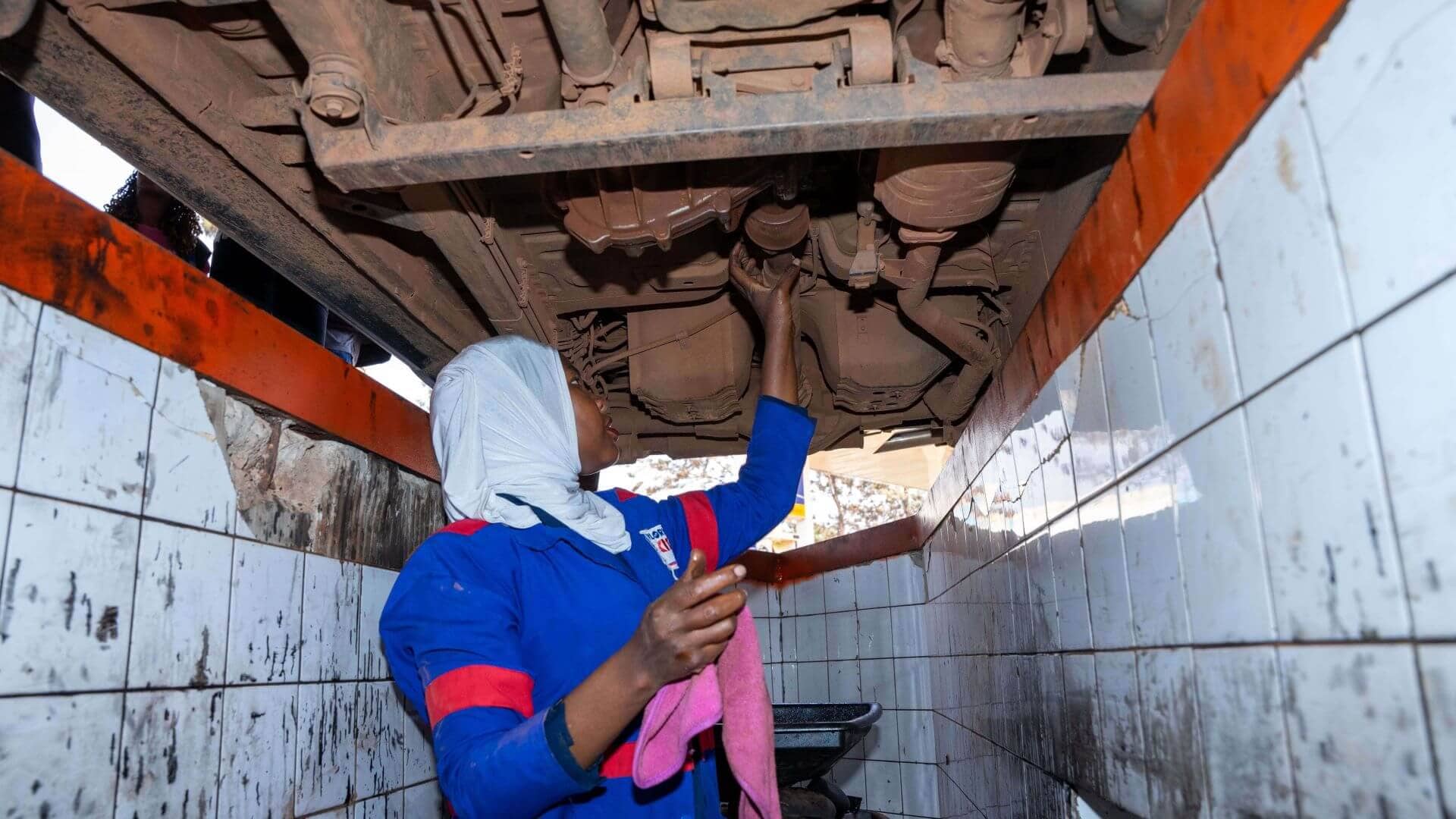 Hajjara performing maintenance on the transfer case. Nampaji transformed from a nurse to a mechanic through Re:BUiLD’s apprenticeship program