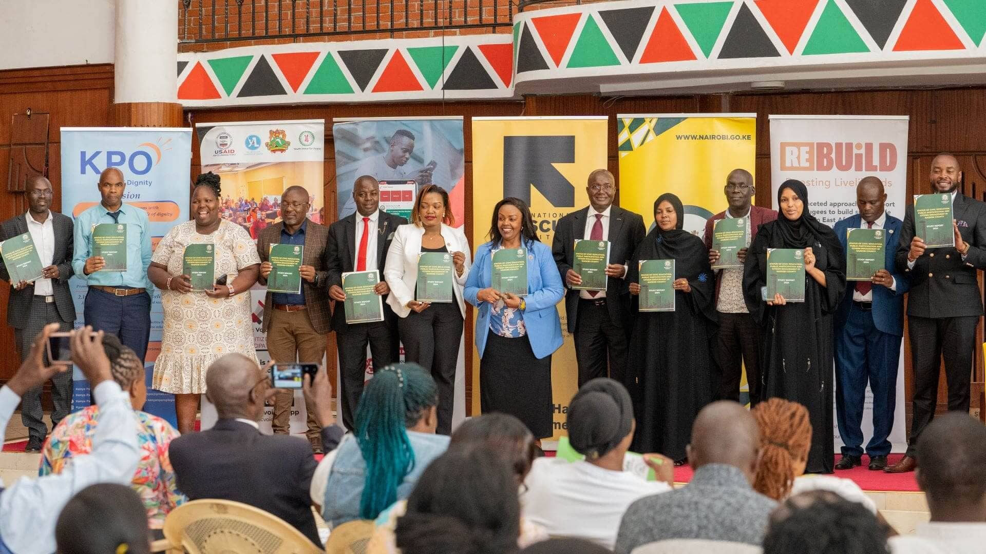 Nairobi County Executive Committee Member in charge of Inclusivity, Public Participation and Customer Service Ms. Rosemary Kariuki (in a blue coat), on behalf of H.E Governor Sakaja launches the Civic Education, Public Participation and Citizen  Engagement status report that primarily seeks to reconfigure the public participation initiatives in Nairobi and ensure there is adequate and  inclusive engagement of the people. (PHOTO: Edgar Otieno for The IRC)