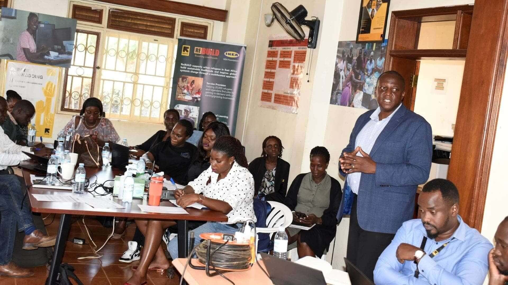 Micheal Kirya (standing), Manager for Agriculture and Agribusiness at the Kampala Capital City Authority (KCCA) presents the KCCA workplan for climate smart livelihoods activities at the SRG meeting