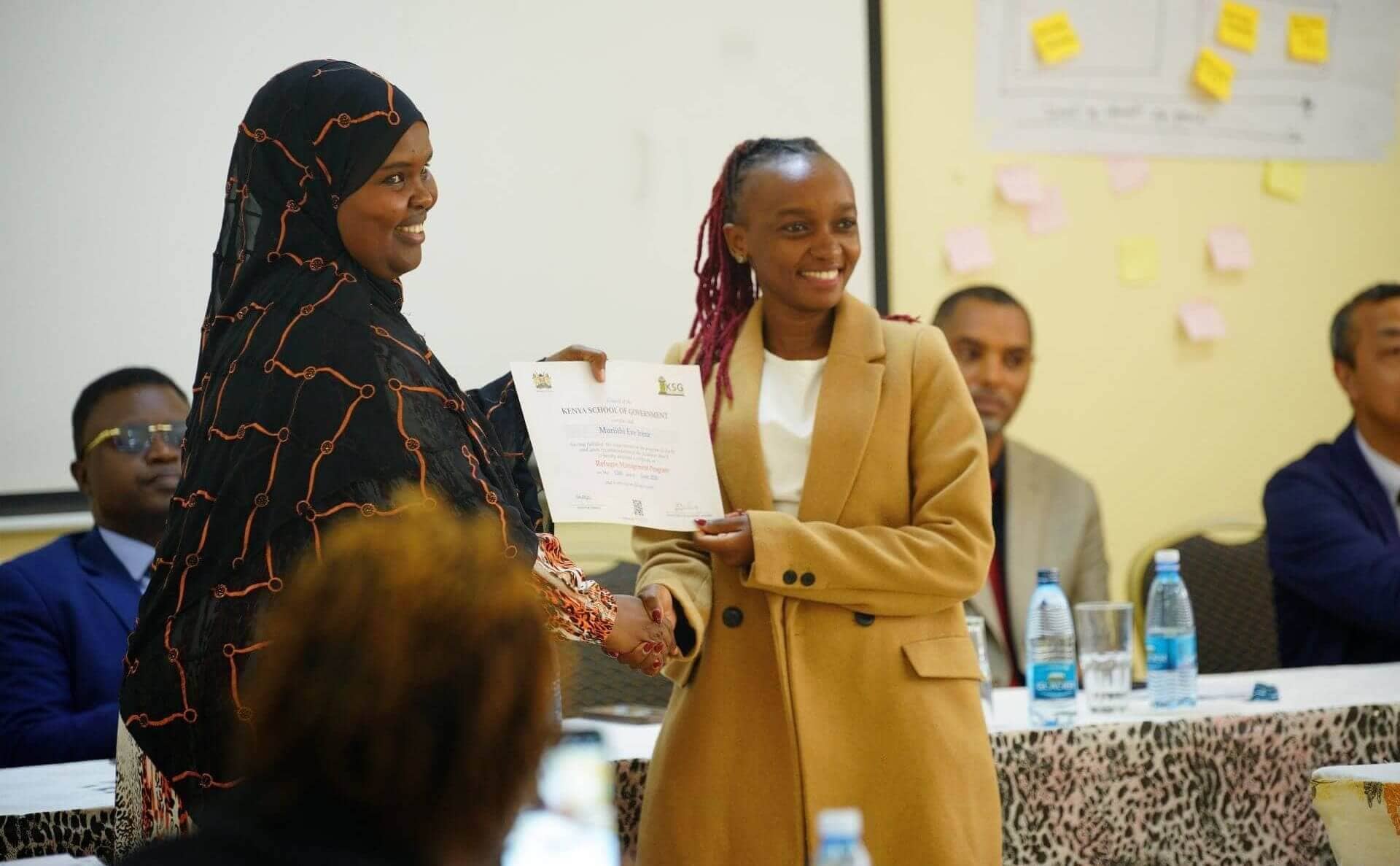 KSG Refugee Programme participant awarded certificate by Ismahan Mohamoud, IRC Officer, after training