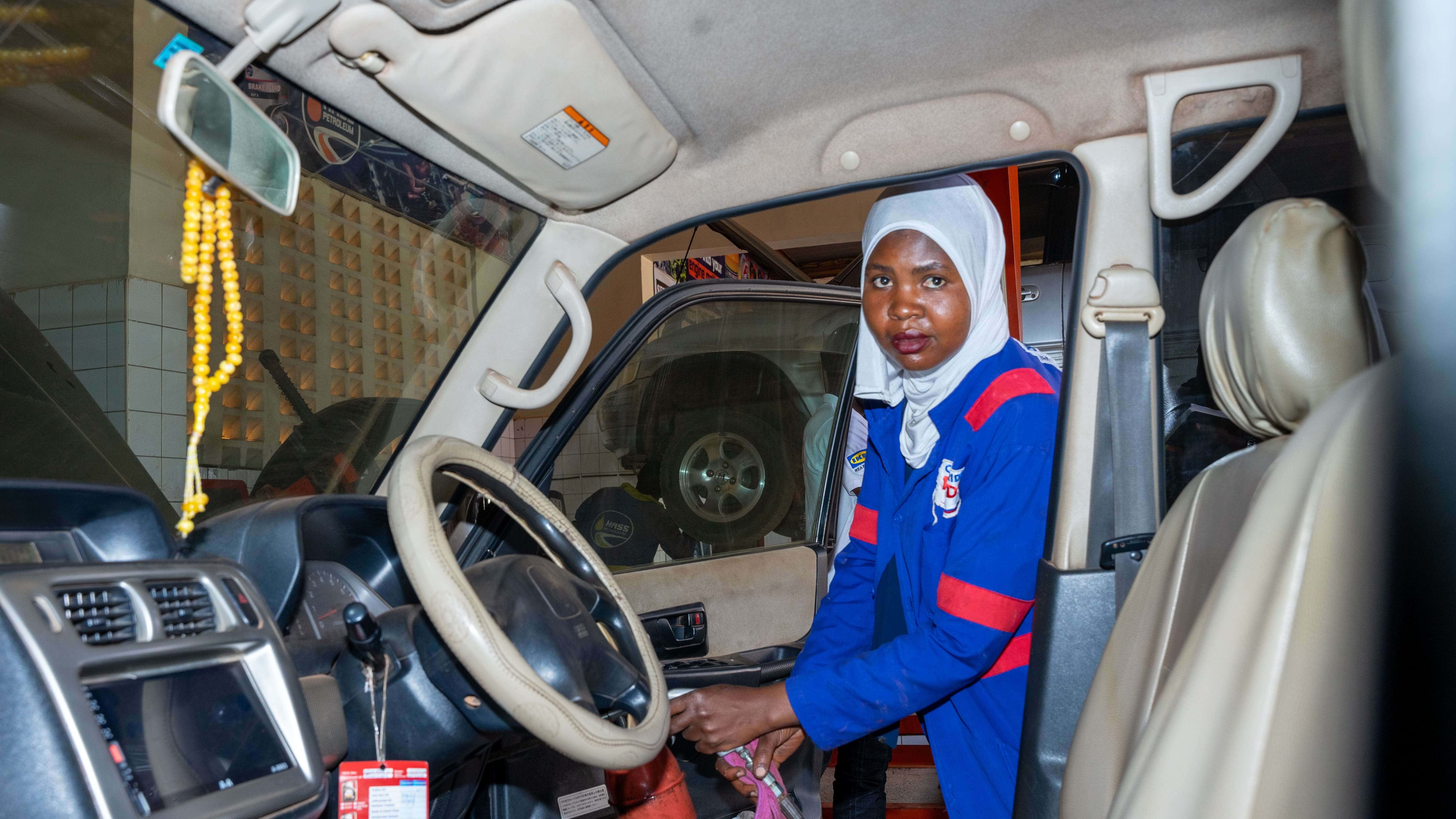 Hajjara Nampaji, cleaning the dashboard. Nampaji transformed from a nurse to a mechanic through ReBUiLD’s apprenticeship program.