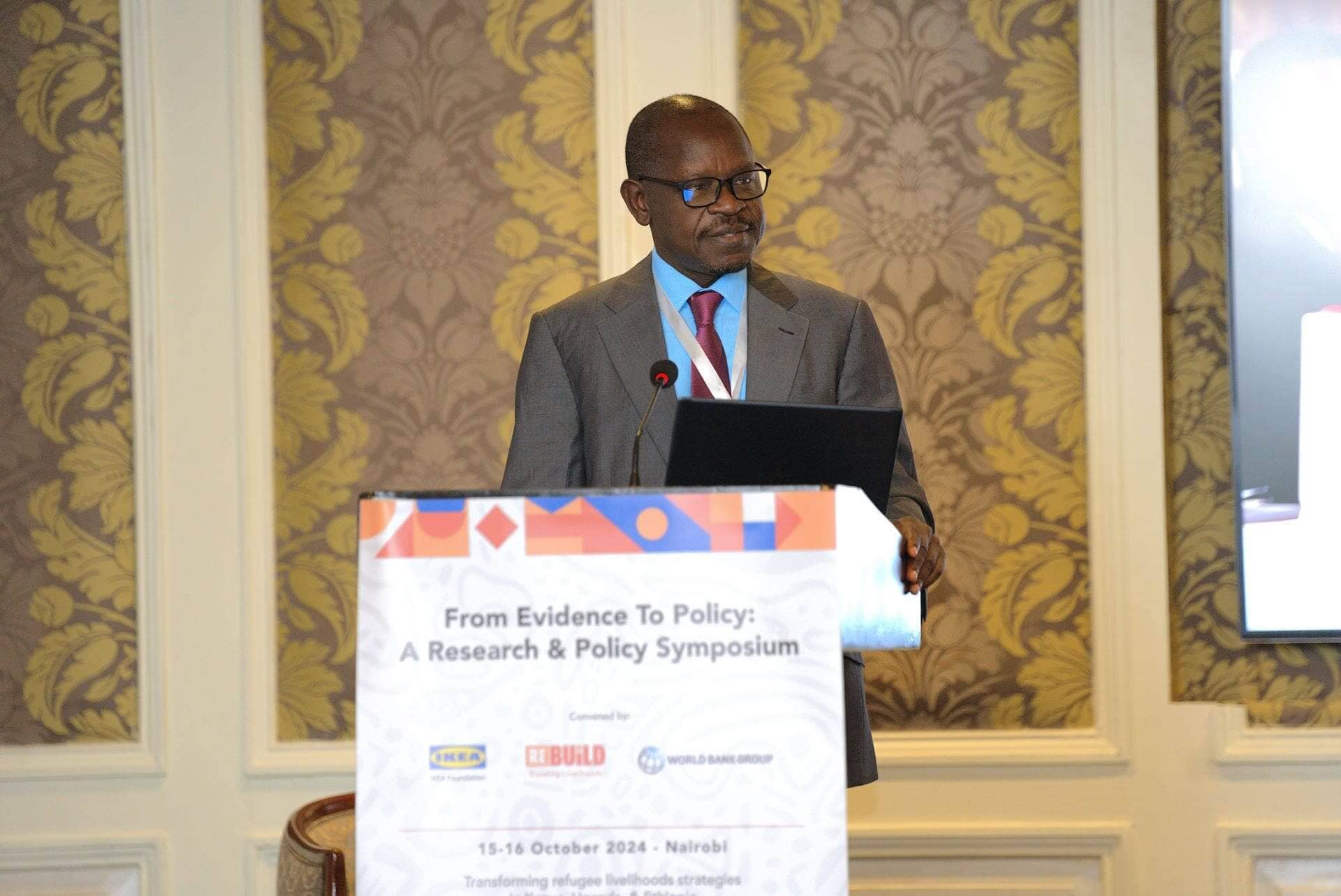 Patrick Okello making a speech at the Research and Policy Symposium, ReBUiLD