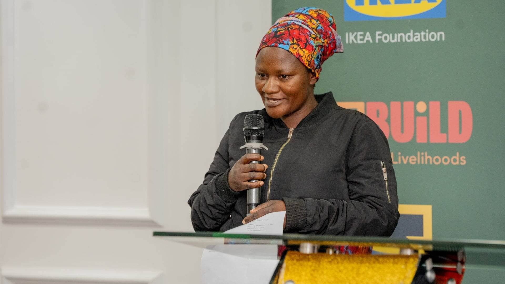 Pelaya Nizigiyimana, a ReBUiLD client shares her story at the RCT Wave 1 results launch, she is one of the clients who benefited from the intervention