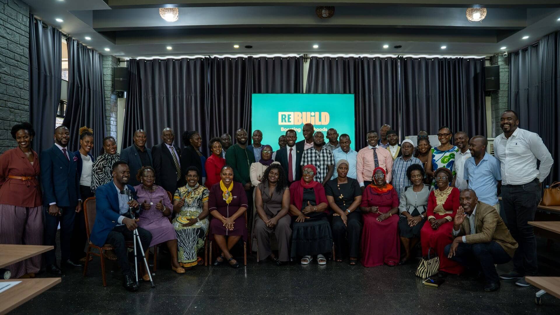 September 01, 2026, Kampala. Political leaders, KCCA officials, religious leaders, refugee representatives, and community stakeholders gather for a group photo after a successful Re:BUiLD engagement. (Photo by Nathan Ijjo Tibaku for the IRC)