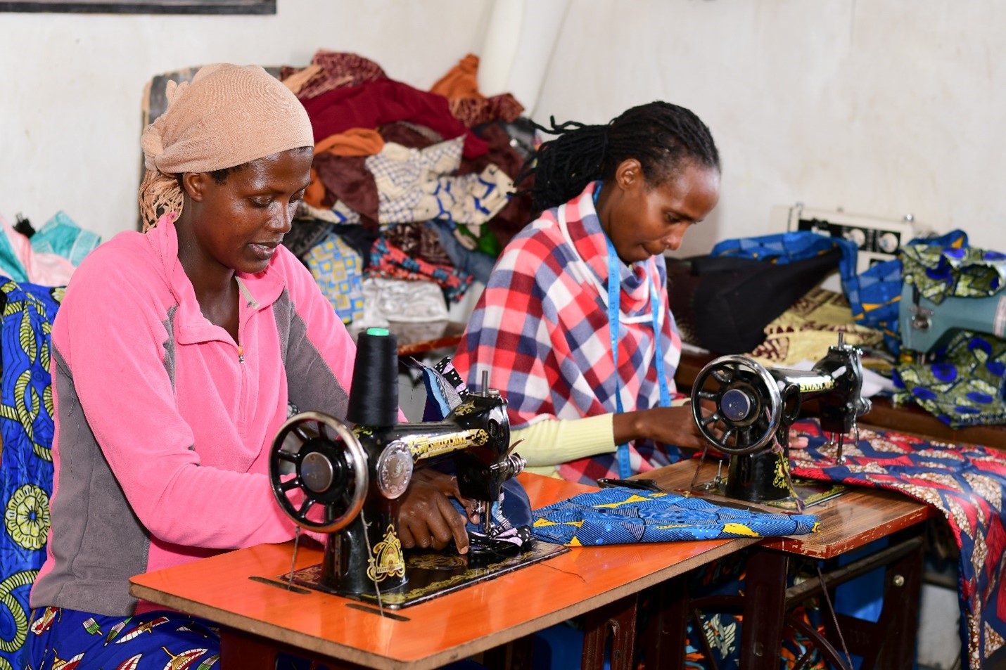 ReBuild clients- Alice Mwamikazi and Immaculate Natusi at work in their tailoring business in Karasani, Nairobi