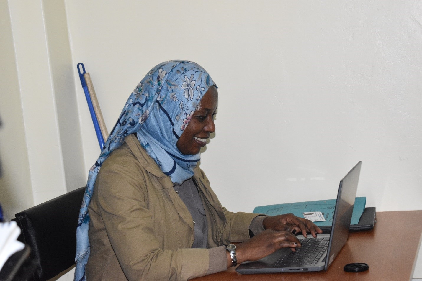 Sarah Haroun Majala at work on her computer - Re:Build