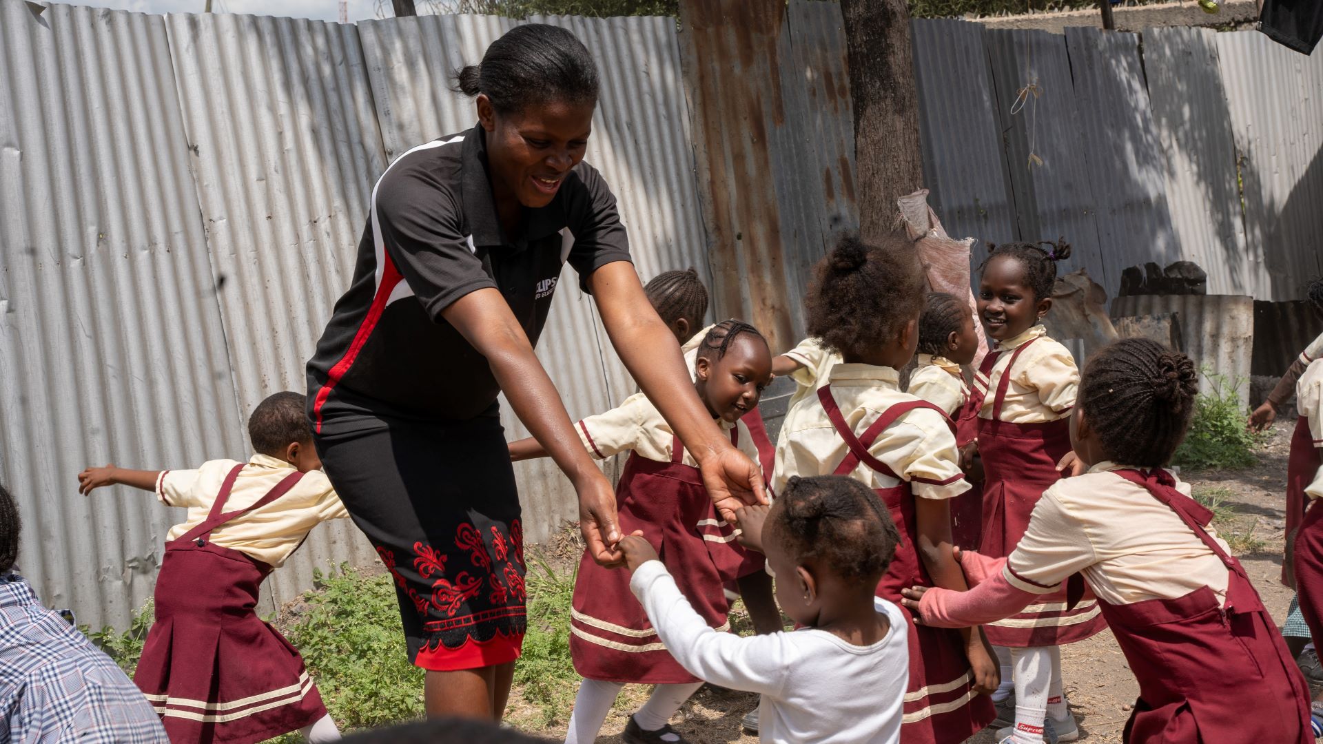 Winnie playing with her students after class time in Kitengela, Nairobi (Photo: Edgar Otieno for IRC)